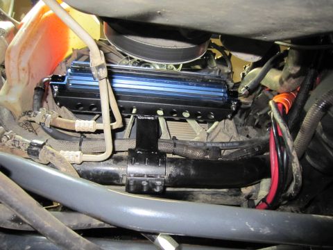 2008 Jeep Wrangler - Aftermarket cooler installed in engine bay, showing hoses and wiring.