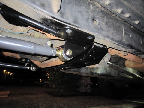 2008 Jeep Wrangler - Close-up view of modified suspension parts on the underside of a vehicle.