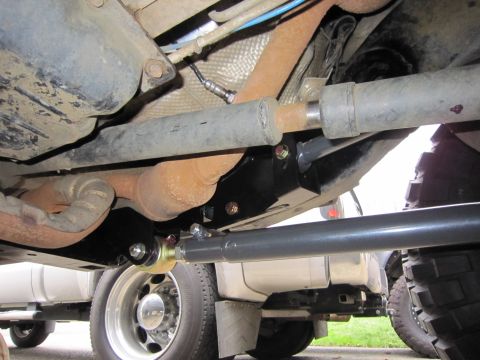 2008 Jeep Wrangler - The underside of a vehicle displays its suspension and exhaust systems, with other trucks in the background.