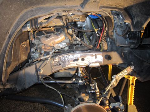 2008 Jeep Wrangler - Close-up of the engine and suspension of a 2007 Jeep Wrangler, showing coilover installation.