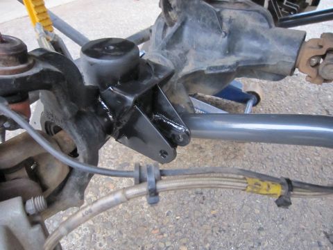 2008 Jeep Wrangler - Close-up view of a Jeep's suspension system, focusing on the differential and brake lines.