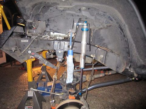 2008 Jeep Wrangler - Close-up of Jeep Wrangler suspension parts, including coilovers and shock absorbers, during maintenance.