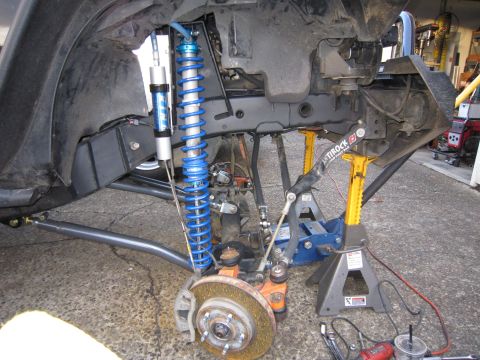 2008 Jeep Wrangler - Close-up of a modified Jeep suspension system, showing coilovers and other components.