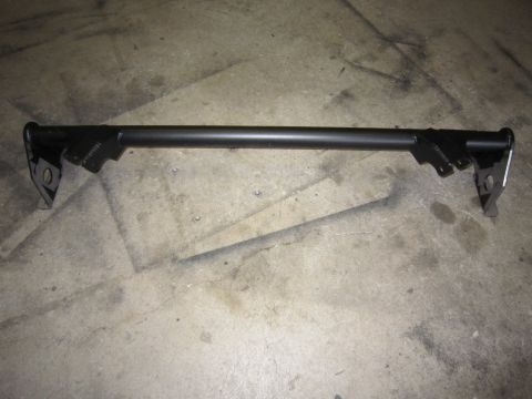 2008 Jeep Wrangler - A fabricated black tubular crossmember or truss bar lying on a concrete garage floor, with welded gusset plates and drilled mounting bracke…