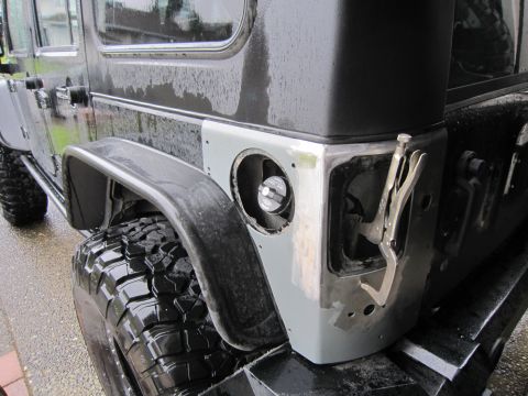 2008 Jeep Wrangler - Close-up of a Jeep Wrangler's rear quarter panel, showing bodywork in progress around the fuel filler opening.