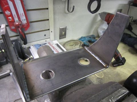 2008 Jeep Wrangler - A custom metal bracket, likely for automotive use, is secured in a vise, with tools and a Washington state license plate visible in the bac…