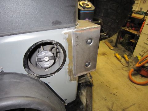 2008 Jeep Wrangler - Rear corner of a silver-gray Jeep with the fuel door removed, showing the exposed filler neck and 'REMOVE SLOWLY' warning gas cap, next to…