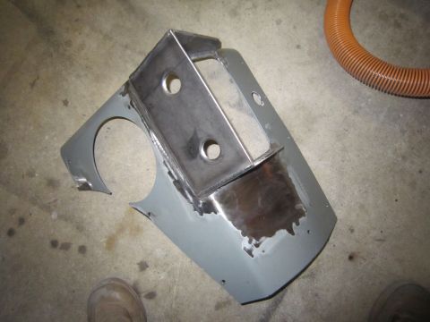 2008 Jeep Wrangler - A fabricated metal bracket is attached to a gray panel, likely a custom automotive part.