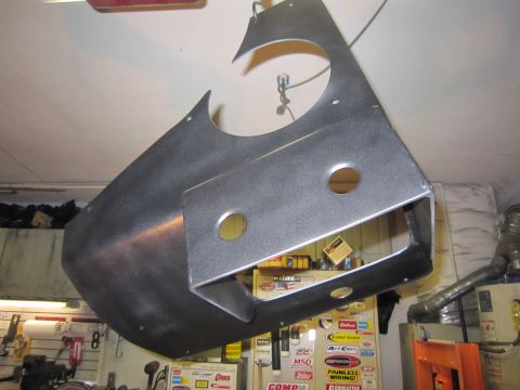2008 Jeep Wrangler - A large fabricated black sheet-metal skid plate or belly pan hanging from a garage ceiling hook, with two round drain holes, a rectangular…