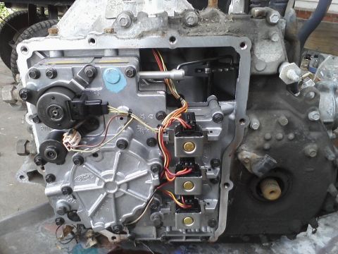 1993 Ford Taurus - Close-up of a Ford transmission valve body, showing internal components and electrical connectors.