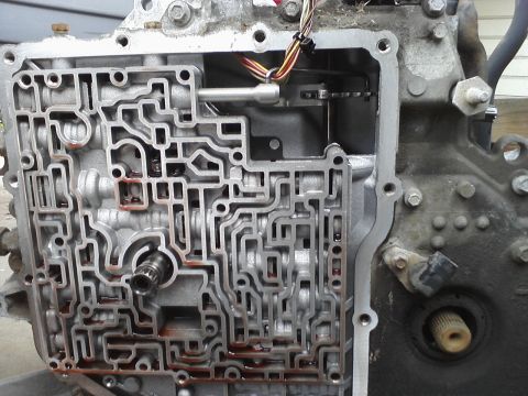 1993 Ford Taurus - Close-up view of an automatic transmission valve body, revealing its complex internal hydraulic passages.