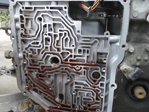 1993 Ford Taurus - Detailed view of an automatic transmission valve body, showing its complex internal hydraulic passages.