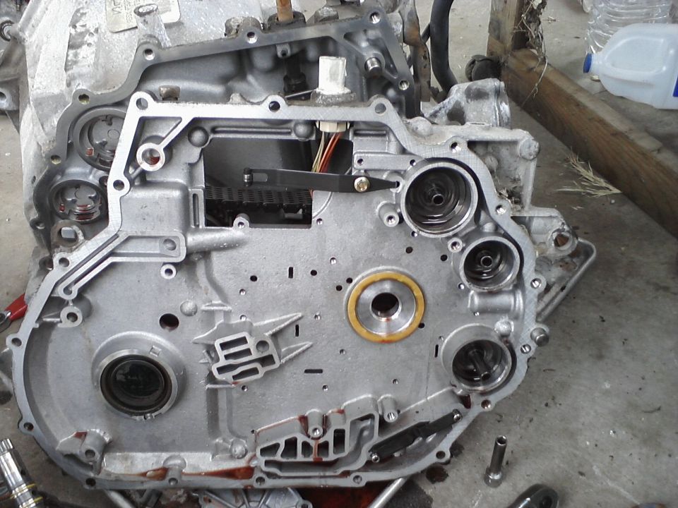 Transmission casing with internal components visible, some fluid residue