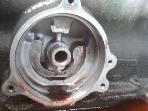 1993 Ford Taurus - Engine oil filter housing showing internal components and some fluid residue.