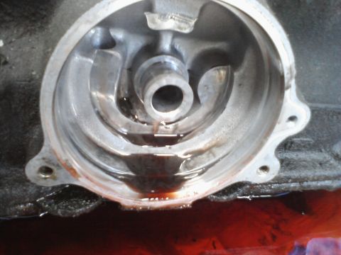 1993 Ford Taurus - This is a close-up view of a vehicle's oil filter housing, showing some residual oil.