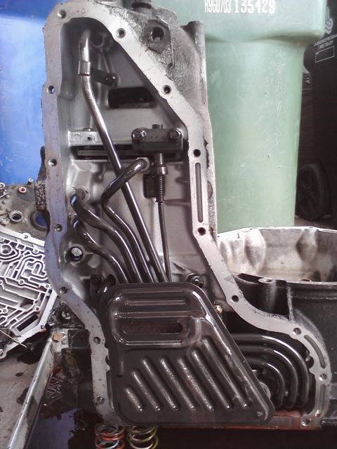 1993 Ford Taurus - Transmission pan and filter removed for service. Internal components are visible.