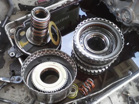 1993 Ford Taurus - Transmission parts laid out for inspection or repair, showing various gears, springs, and other internal components.