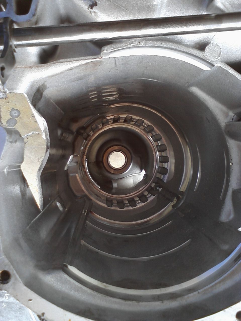 Interior view of a transmission torque converter housing with internal splines visible