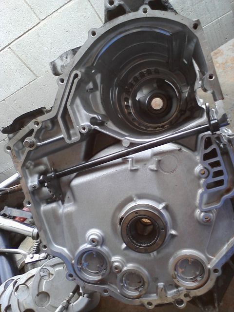 1993 Ford Taurus - Close-up of a disassembled transmission housing, showing internal components and a connecting rod.