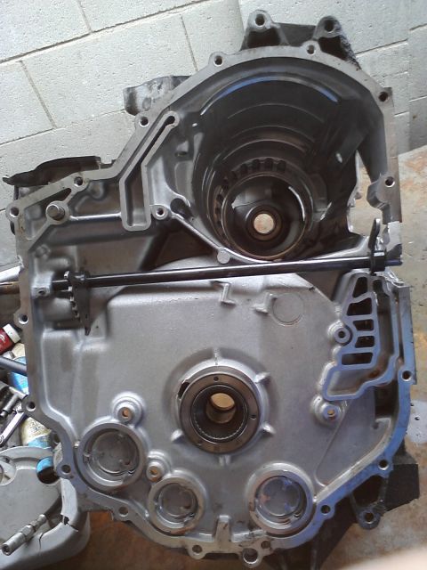 1993 Ford Taurus - Close-up view of a disassembled transmission case, showing internal components like gears and bearings.