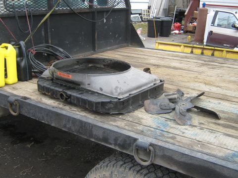1972 Ford F-250 - A radiator and fan assembly, along with some fluids, are loaded onto a flatbed trailer.