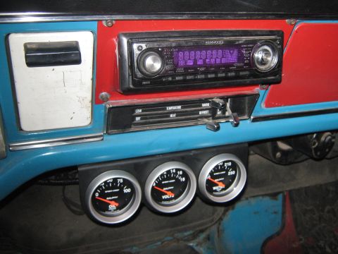 1972 Ford F-250 - Aftermarket gauges for oil, voltage, and water are installed below the stereo on the dashboard.