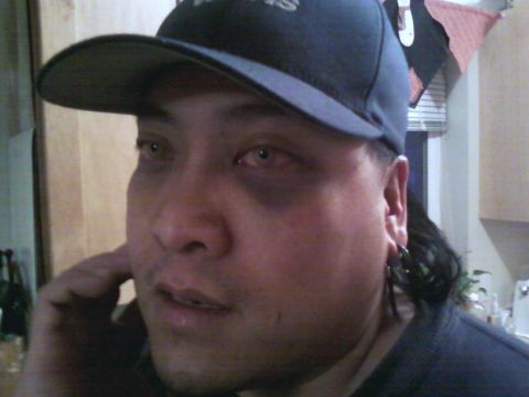 2006 Ford E350 - A person in a baseball cap is captured in a close-up shot, with their gaze directed away from the camera.