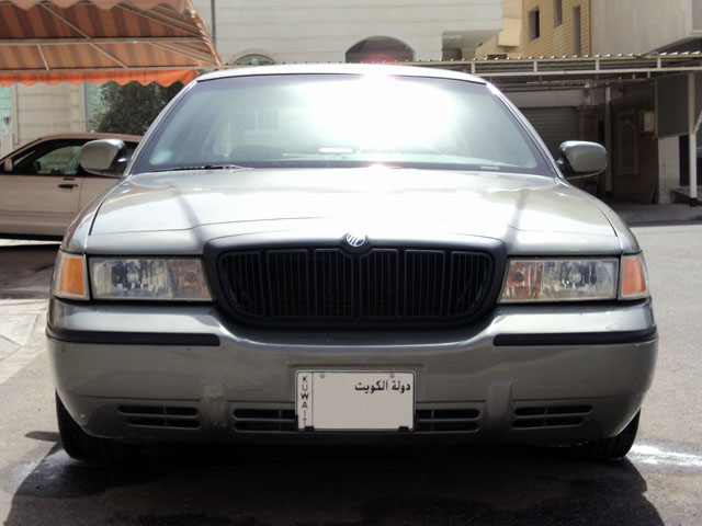 Front view of silver Mercury sedan with blacked-out grille and Kuwait license plate