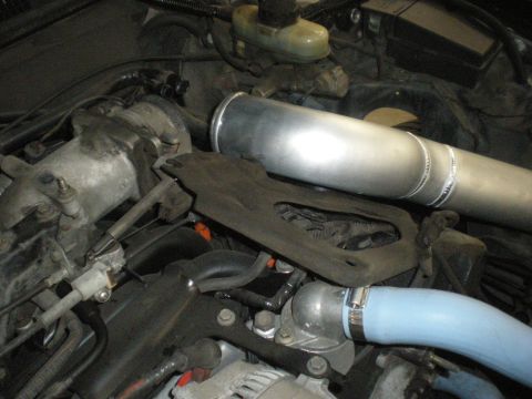 1998 Ford Crown Victoria - Close-up view of an engine bay, focusing on custom intercooler piping and associated engine parts.