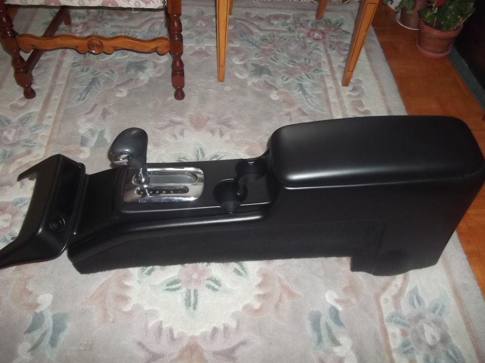Black car console with gear shifter and cup holders