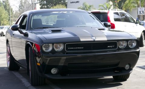 2006 Cadillac STS - A black Dodge Challenger SRT is parked in a lot, with a white SUV visible in the background.