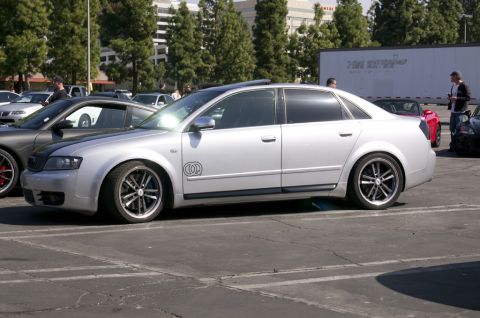 2006 Cadillac STS - Silver sedan with custom wheels parked in a lot with other vehicles.