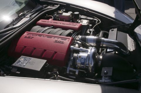 2006 Cadillac STS - Engine bay features red Corvette LS7 7.0L engine covers and a prominent supercharger.