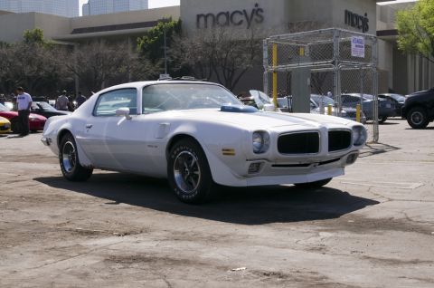 2006 Cadillac STS - A white 1970 Pontiac Firebird is seen parked in a lot with a Macy's store in the background.