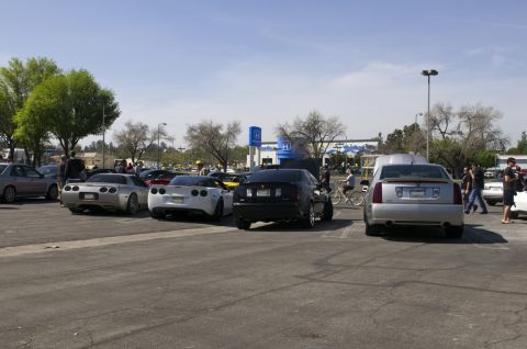 2006 Cadillac STS - Several cars are parked in a lot on a sunny day, including a silver Cadillac CTS.