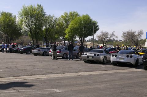 2006 Cadillac STS - A gathering of sports cars, including Corvettes, are parked in an outdoor lot on a sunny day.