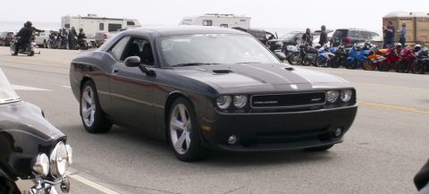 2006 Cadillac STS - A dark gray Dodge Challenger SRT8 is parked on a street, with several motorcycles and RVs in the background.