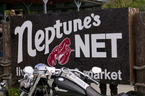2006 Cadillac STS - A motorcycle is parked in front of the Neptune's Net sign.
