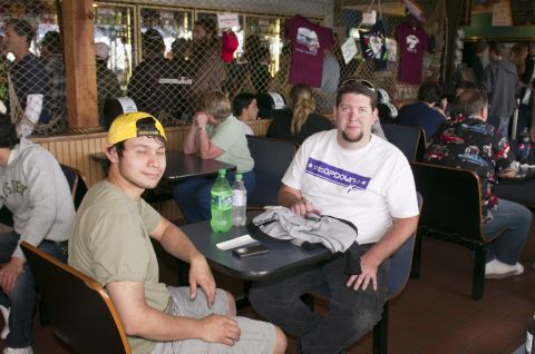 2006 Cadillac STS - People are gathered inside a casual establishment, with merchandise displayed in the background.
