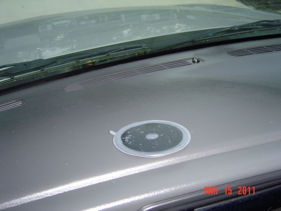 Dashboard of a vehicle with a circular object on it, near the windshield. Date stamp 'MAY 15 2011 SUPERMOTORS www.supermotors.net' is visible