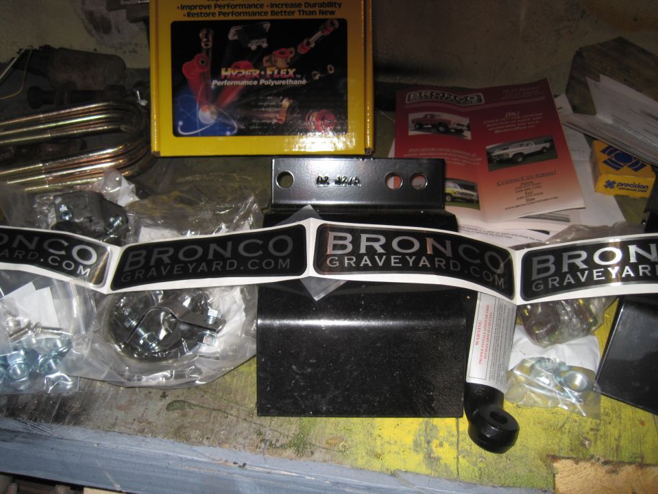 Stickers that say BRONCOGRAVEYARD.COM, a yellow box with performance polyurethane, and various metal parts