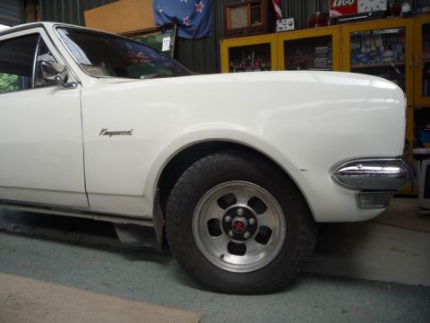 1969 Lincoln Continental - A white sedan, possibly a Holden Kingswood, is shown from the side with custom wheels.