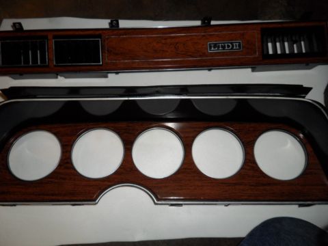 1973 Ford Ranchero - Dashboard trim panel wood grain accents and an 'LTD II' badge, likely from a Ford vehicle.