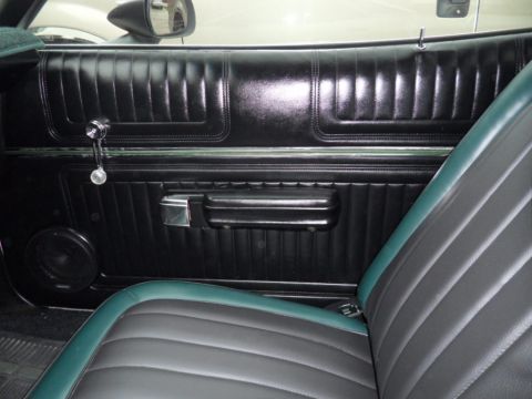 1973 Ford Ranchero - Interior view of a 1973 Ford Ranchero, showing the door panel and seat upholstery.