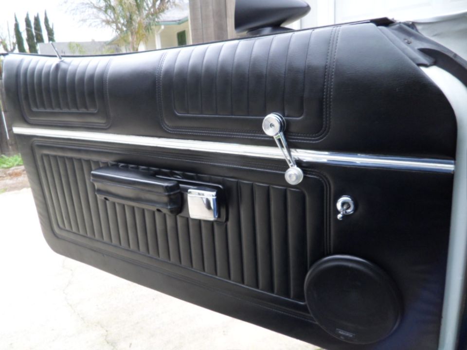black vinyl door panel with chrome window crank and door handle