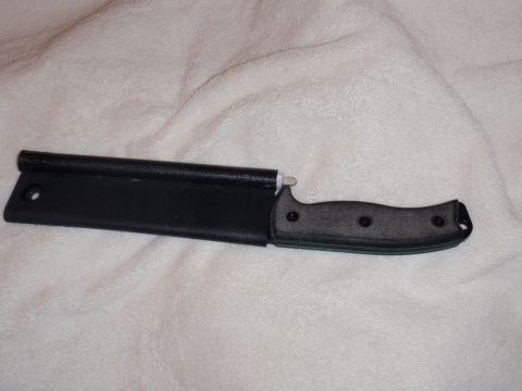 1991 Ford Bronco - A knife with a dark, textured handle is shown partially inserted into its black sheath against a white, textured background.