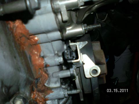 1996 Ford Bronco - Close-up engine bay photo of an ignition module and connector with heavy orange surface rust on adjacent castings, dated March 15 2011.