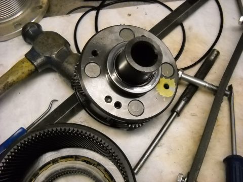 1993 Ford C-150 (Centurion Conversions) - Close-up of transmission components and tools laid out on a surface, suggesting repair or maintenance work.