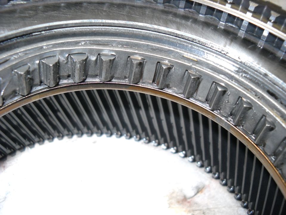 Close-up of a metal ring with teeth and ball bearings inside