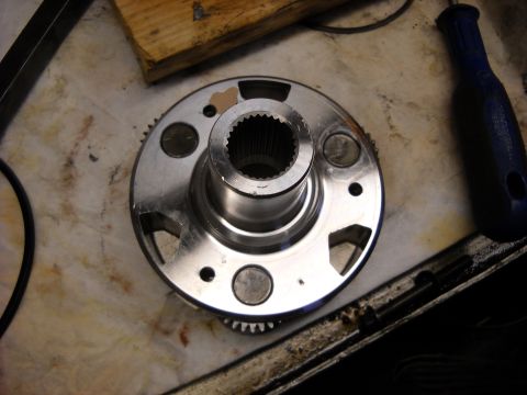 1993 Ford C-150 (Centurion Conversions) - A metal transmission component with a splined center and gear teeth on its outer edge is shown.